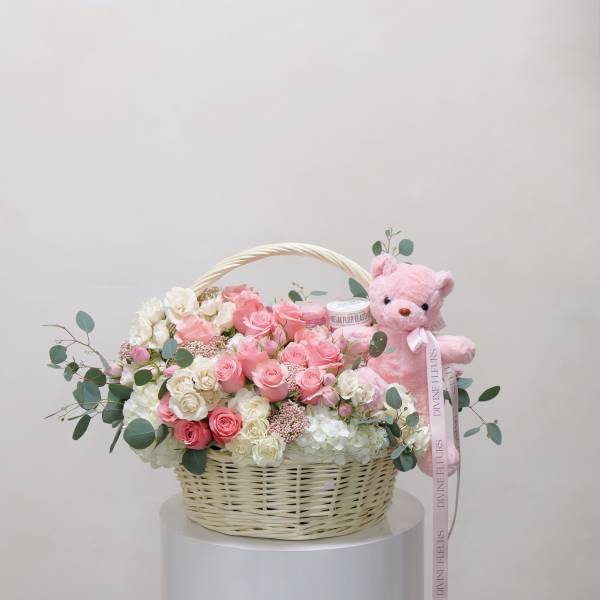 Pink and white rose basket with a pink teddy bear