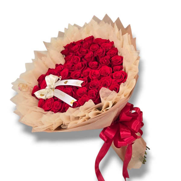 Bouquet of red roses wrapped in beige paper with a red ribbon