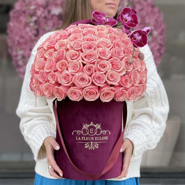 Large pink rose bouquet in a burgundy hatbox with purple orchids