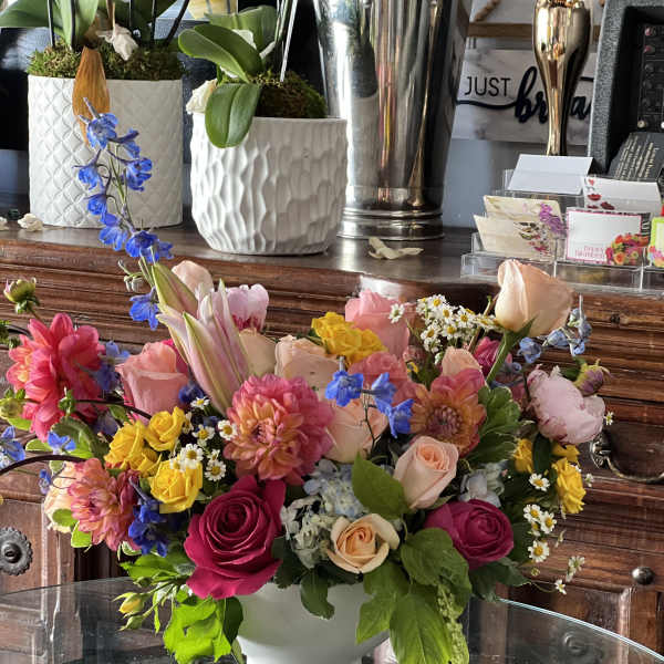 Colorful mixed flower arrangement in a white vase