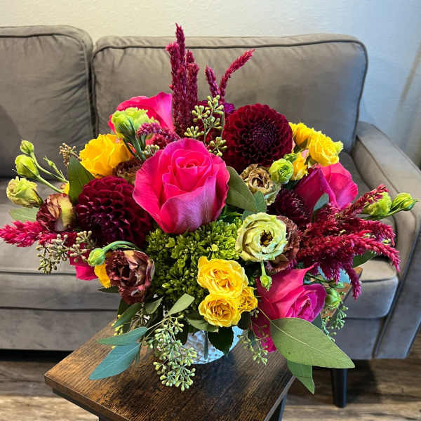 Bright mixed bouquet with pink roses, yellow blooms, and burgundy flowers