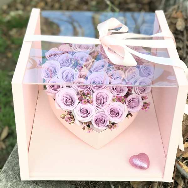 Lavender rose bouquet in a pink gift box with a ribbon bow