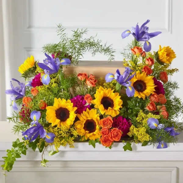 Bright mixed bouquet with sunflowers, purple irises, and orange roses