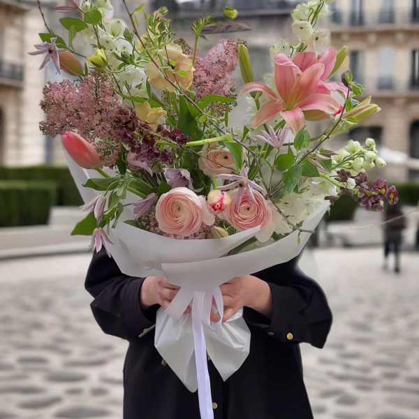 Hand-tied bouquet of pink and white flowers with a white wrap