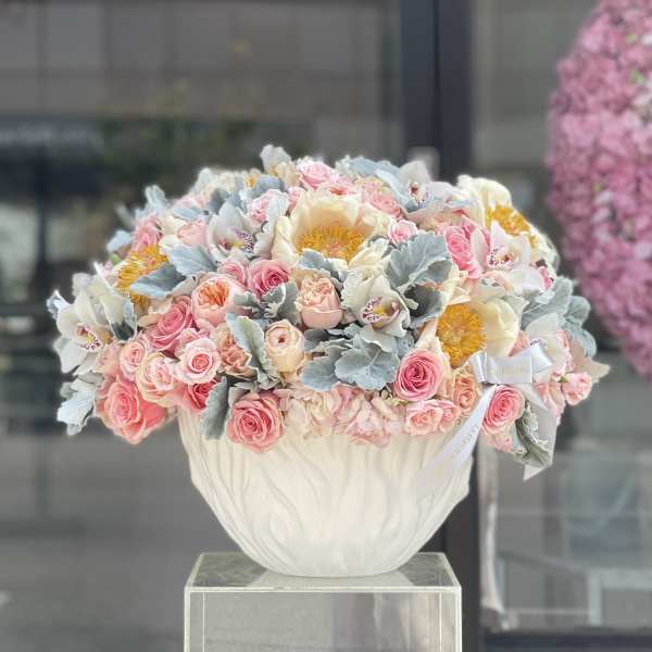 Pink and white floral arrangement in a white vase