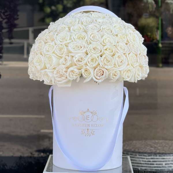 Large dome of white roses in a white hatbox