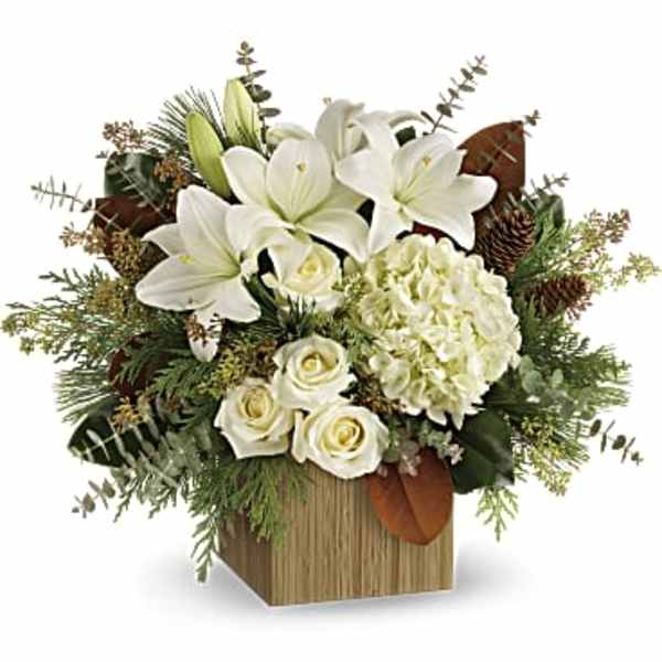 White lilies and roses arranged in a wooden box