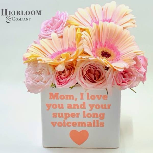 Pink and peach flowers in a white box with a Mother's Day message
