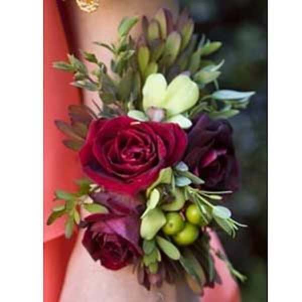 Small bouquet with deep red roses and pale green flowers