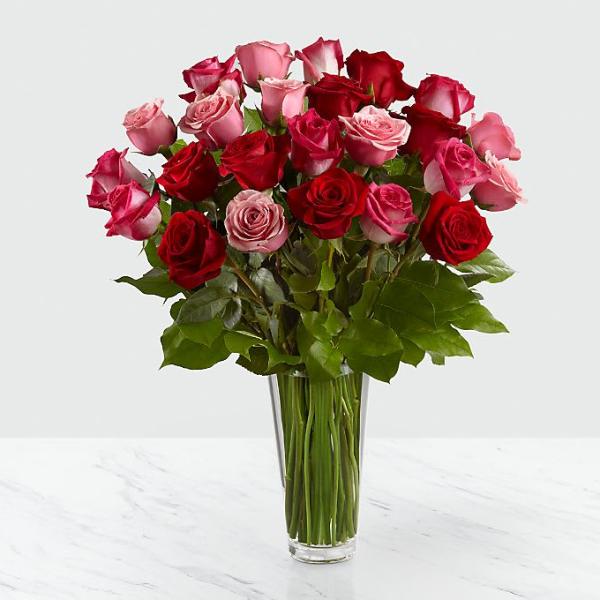 Bouquet of red and pink roses in a clear glass vase