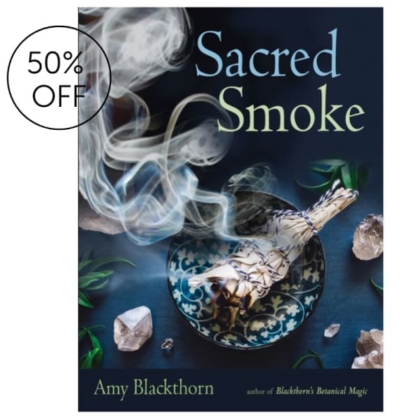 Book cover with smoke, a sage bundle, and crystals