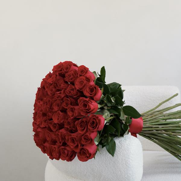 Large bouquet of red roses with green leaves