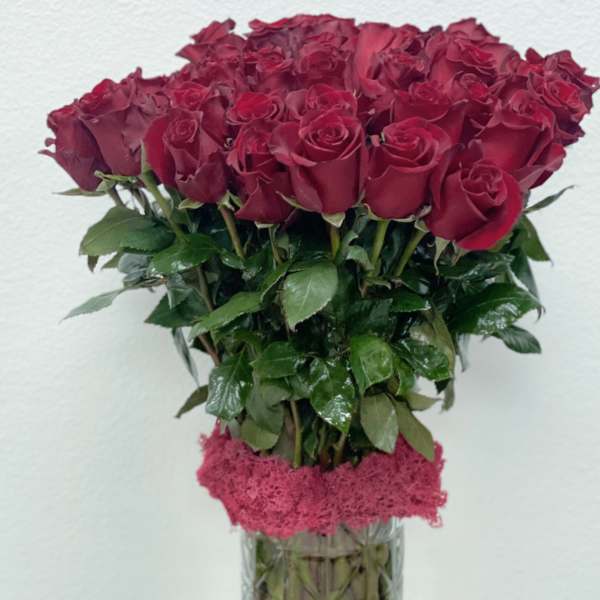 Bouquet of deep red roses in a clear glass vase