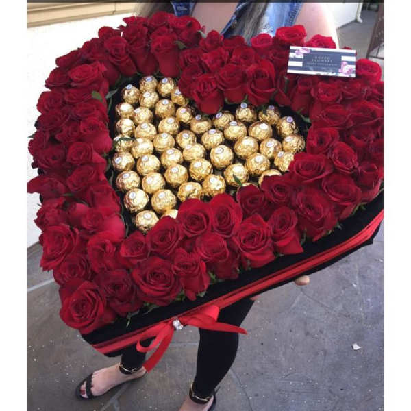 Heart-shaped box of red roses with gold-wrapped chocolates