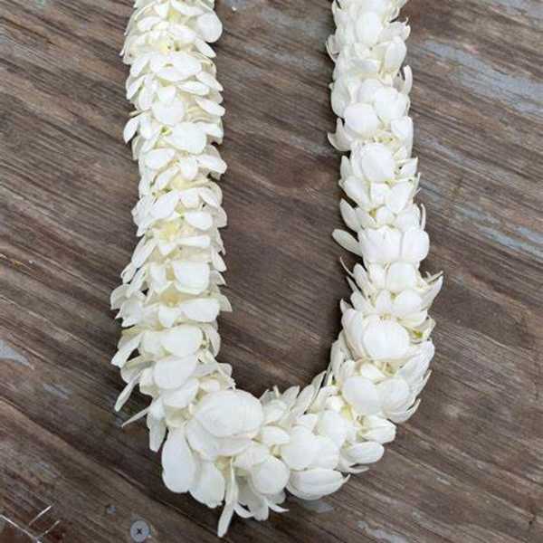 White flower lei on a wooden surface