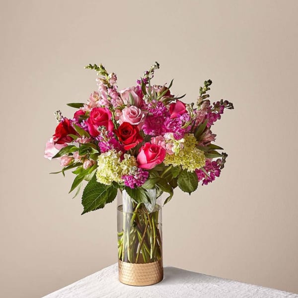 Pink and red rose bouquet in a clear glass vase