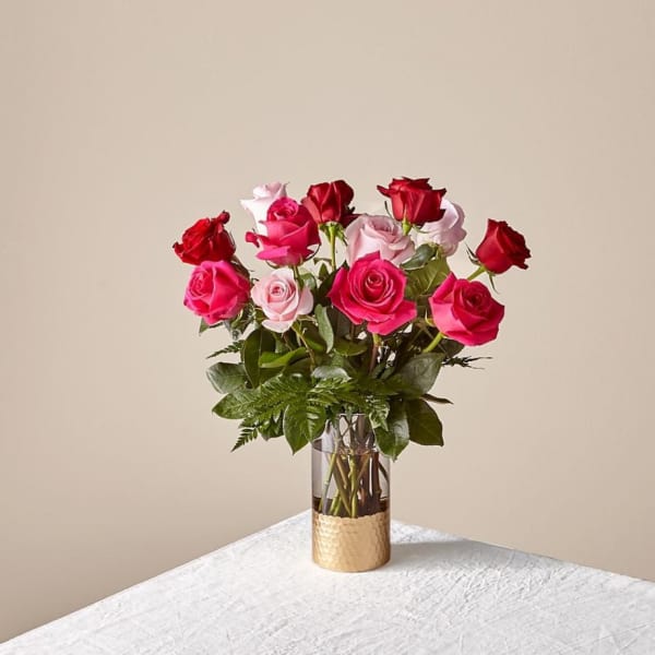Bouquet of pink and red roses in a clear glass vase