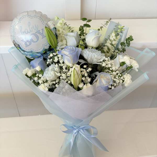 Bouquet of white and pale blue flowers with a baby boy balloon
