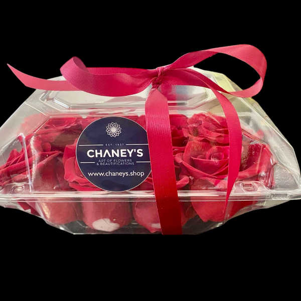 Clear gift box of red roses tied with a pink ribbon