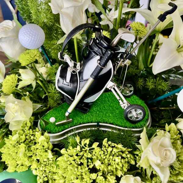 Golf-themed floral arrangement with white roses and golf clubs