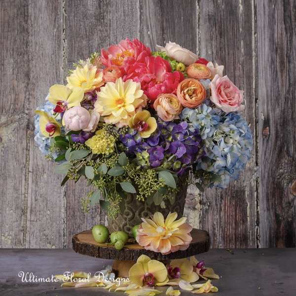 Colorful bouquet in a decorative vase with hydrangeas, roses, and orchids