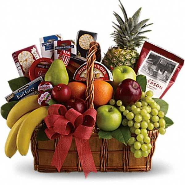 Fruit basket with bananas, grapes, pineapple, apples, and snack packages