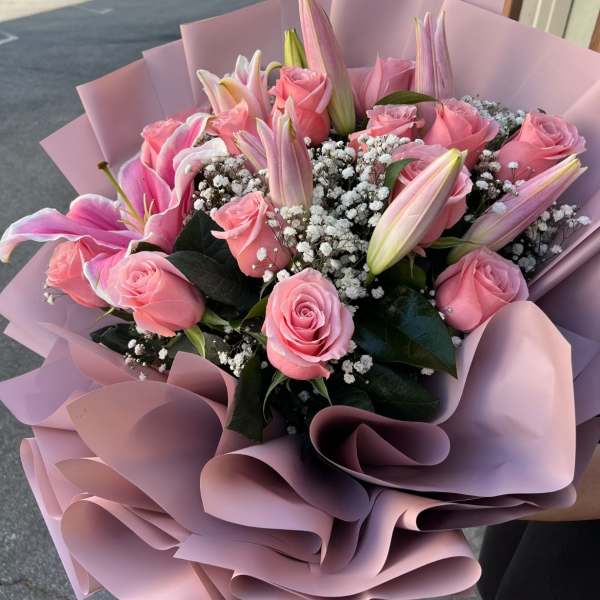 Pink roses and lilies in pastel pink wrapping