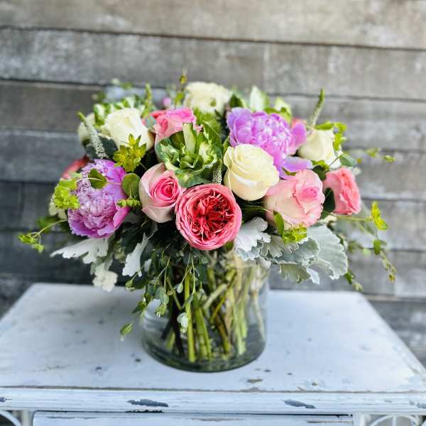 Mixed pink and white roses in a glass vase