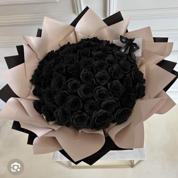 Bouquet of black roses wrapped in blush and black paper