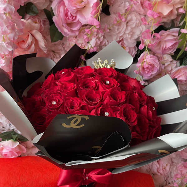 Bouquet of red roses wrapped in black and white paper with a red ribbon