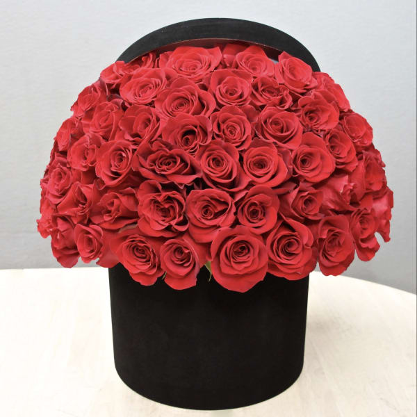 Large bouquet of red roses in a black box