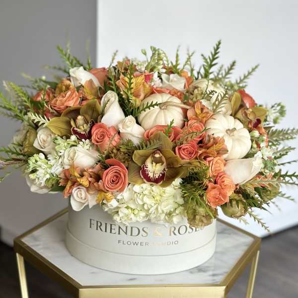 Mixed bouquet in a round white box with white, peach, and coral flowers