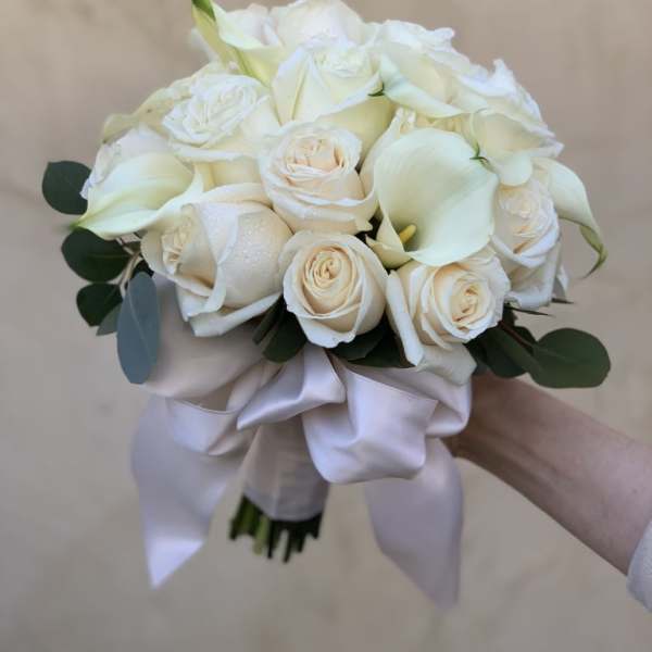 White rose and calla lily bouquet with a satin ribbon