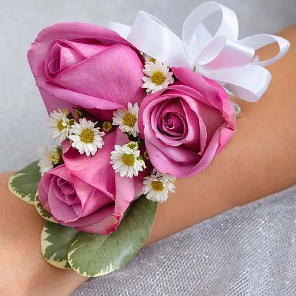 Pink rose wrist corsage with white ribbon and small white daisies