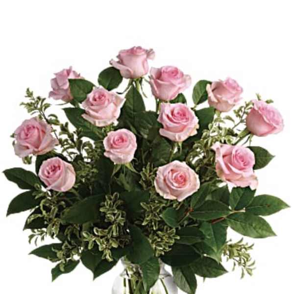 Pink roses arranged in a clear glass vase