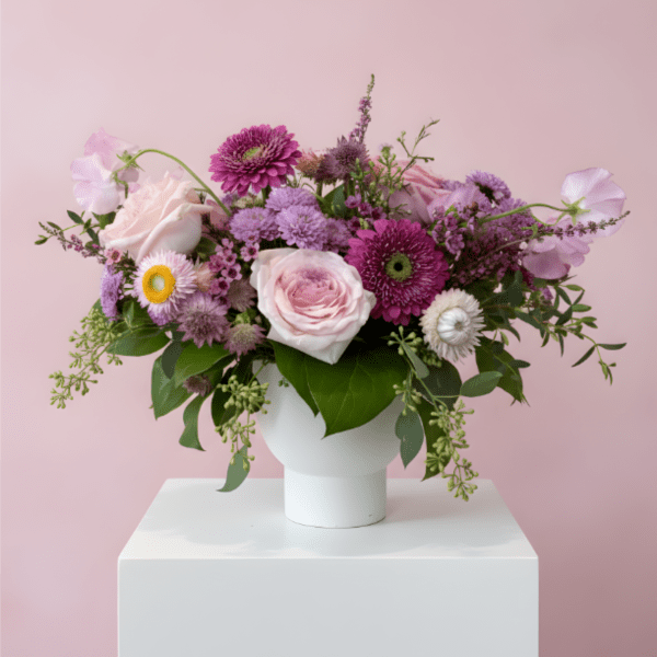 Pink and purple mixed bouquet in a white vase