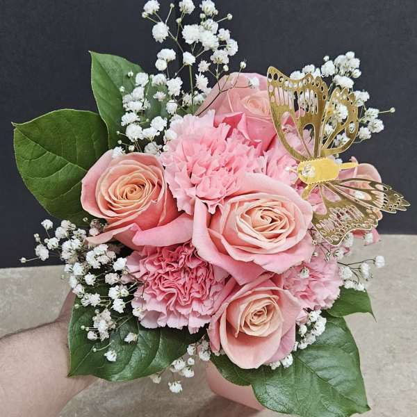 Pink rose and carnation bouquet with white baby's breath and a gold butterfly pick