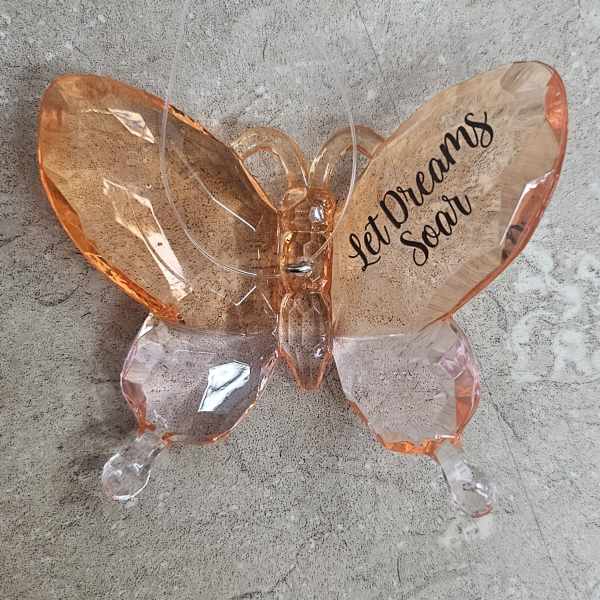 Butterfly-shaped decorative balloon with "Let Dreams Soar" text