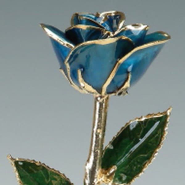 Blue rose with gold-edged petals and green leaves