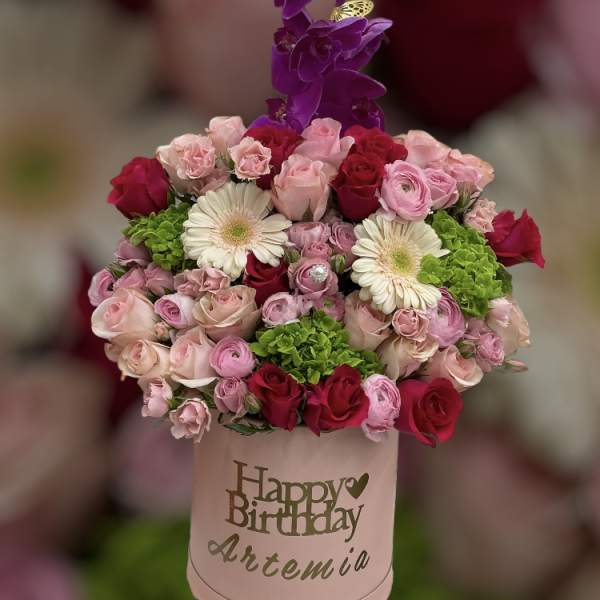 Pink and red rose bouquet with purple orchids in a birthday box