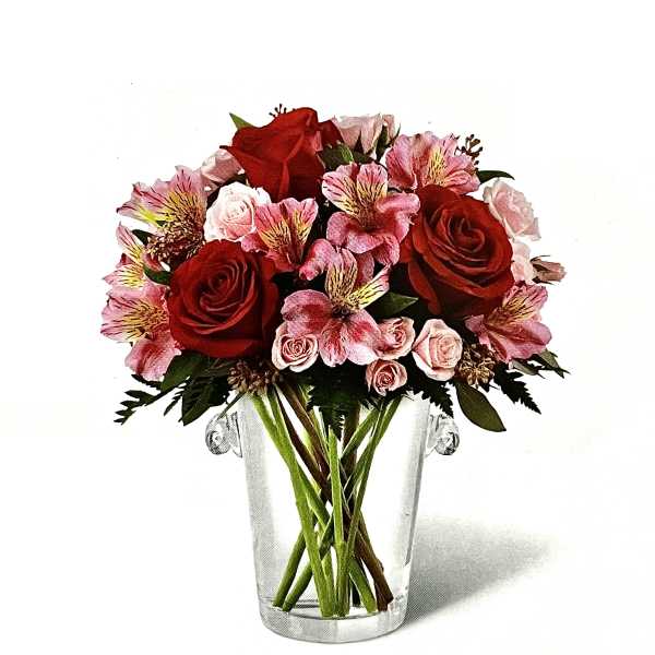 Red and pink flower bouquet in a clear glass vase