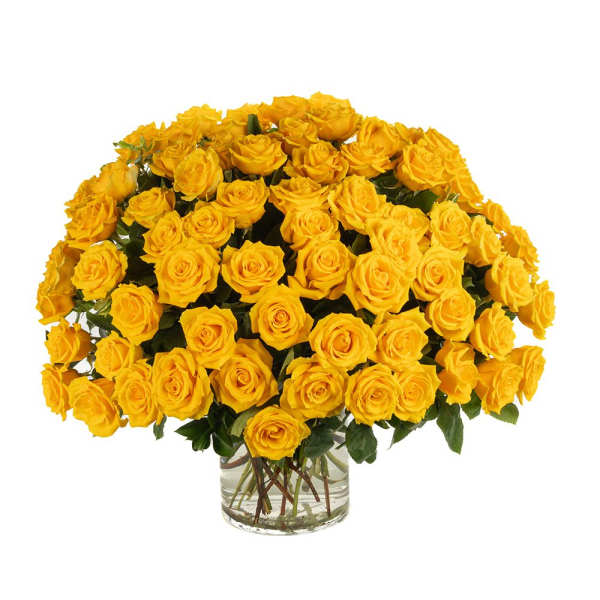 Large arrangement of yellow roses in a clear glass vase
