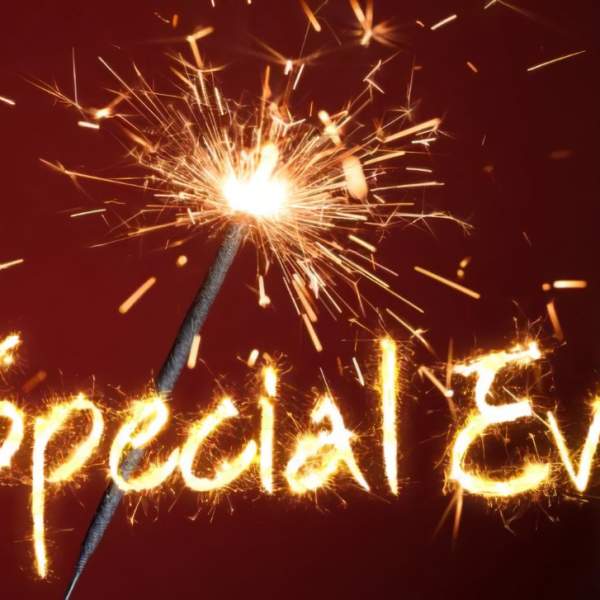 Sparkler writing "Special Events" on a dark red background