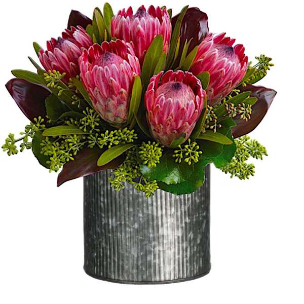 Pink protea bouquet in a ribbed metal vase