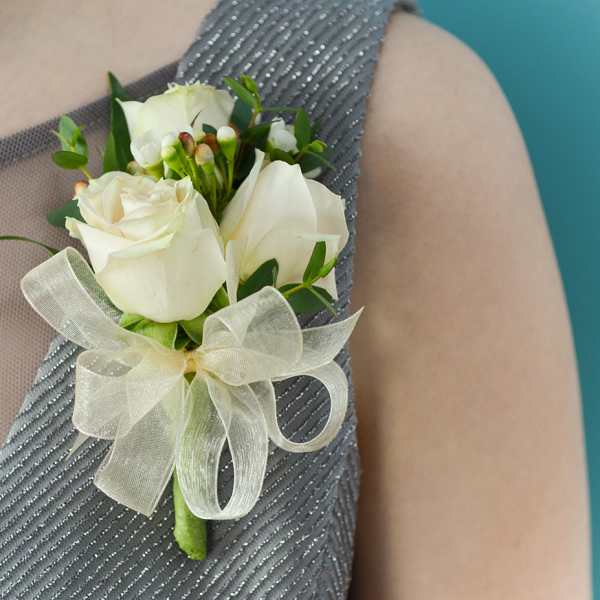 White rose boutonniere with a sheer ribbon bow