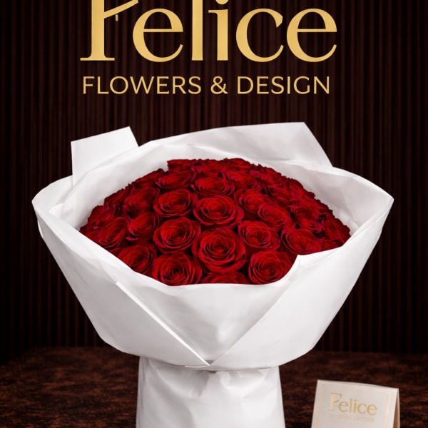 Bouquet of red roses wrapped in white paper