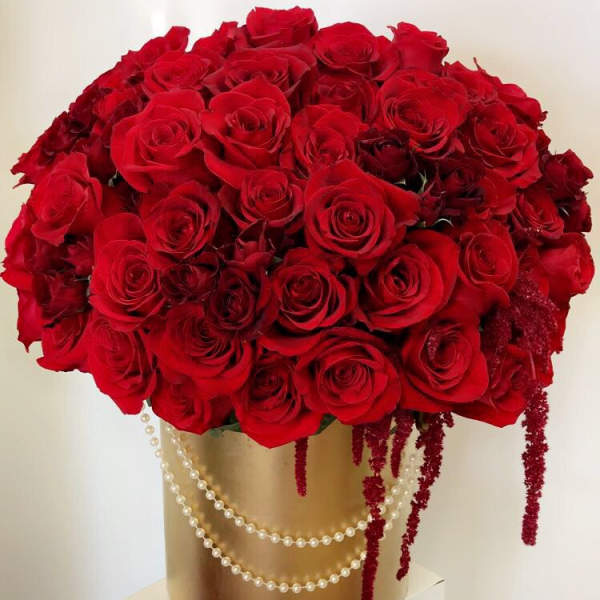 Large bouquet of red roses in a gold box with pearl strands
