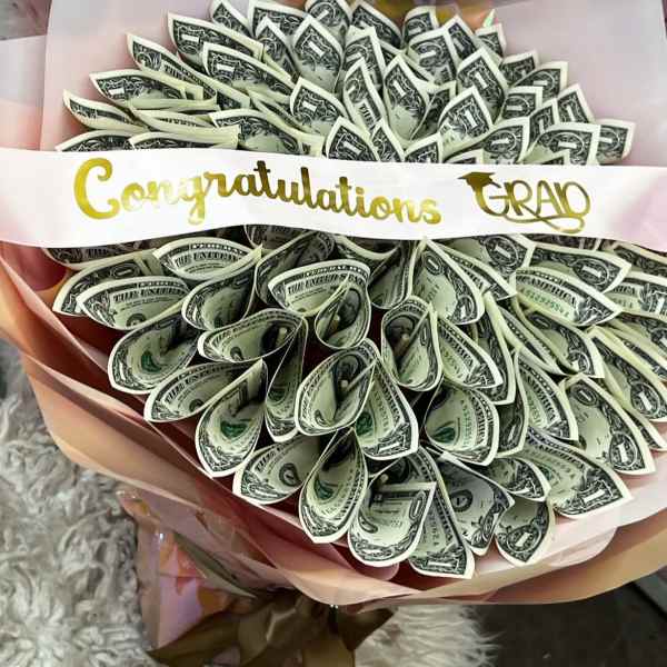 Bouquet made of folded one-dollar bills with a congratulations ribbon