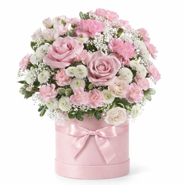 Pink and white roses in a round pink box with a satin bow