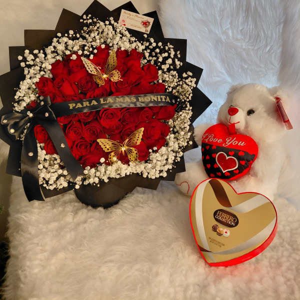 Red rose bouquet with baby's breath, a teddy bear, and heart-shaped chocolates